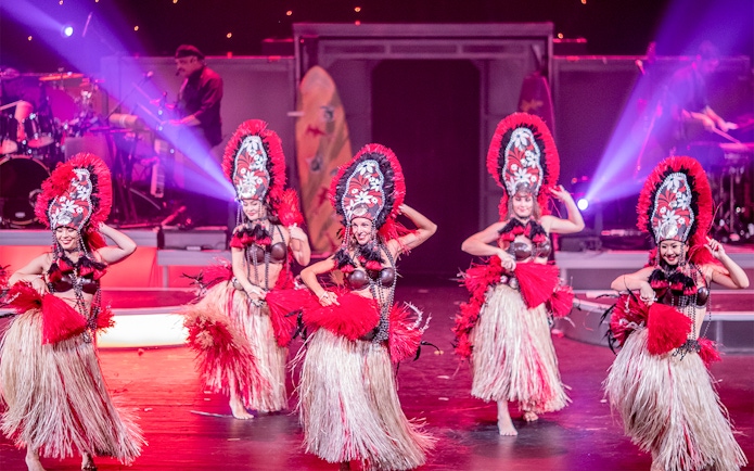 Dancers performing in traditional costumes at Rock-A-Hula Show in Honolulu.