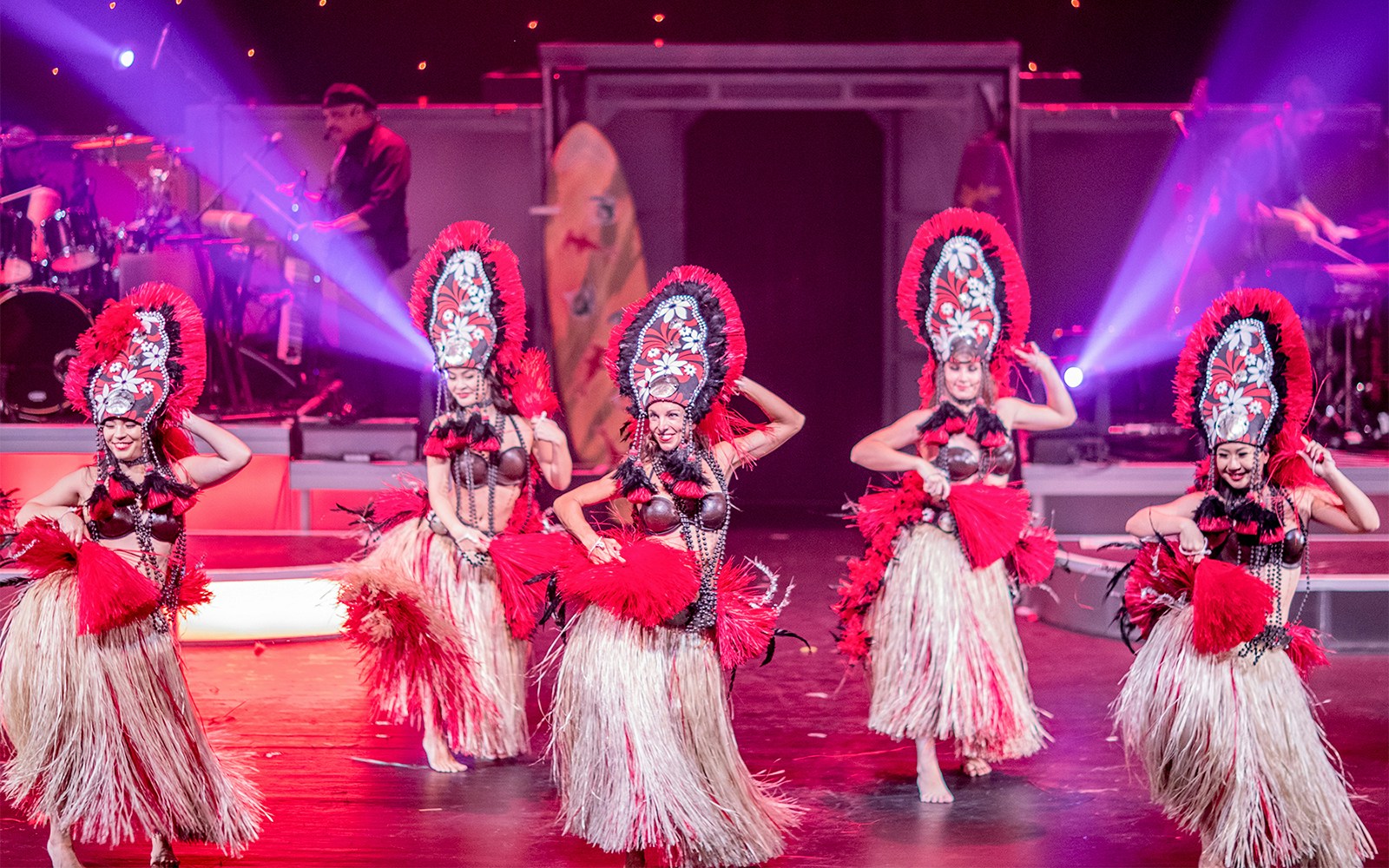 Dancers performing in traditional costumes at Rock-A-Hula Show in Honolulu.