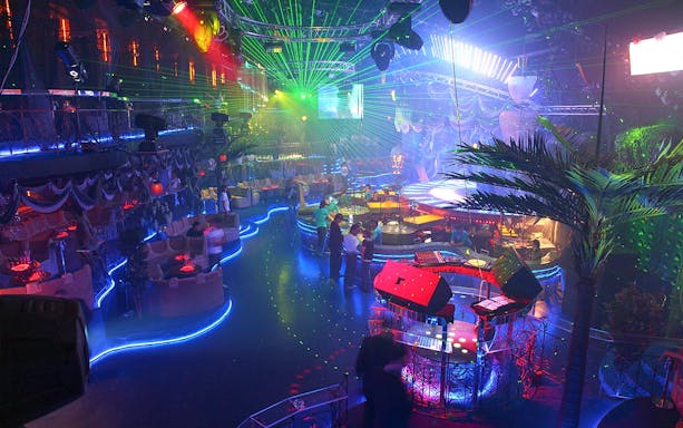 Nightclub interior with vibrant lights and dance floor at PICCADILLY UMEDA Osaka.