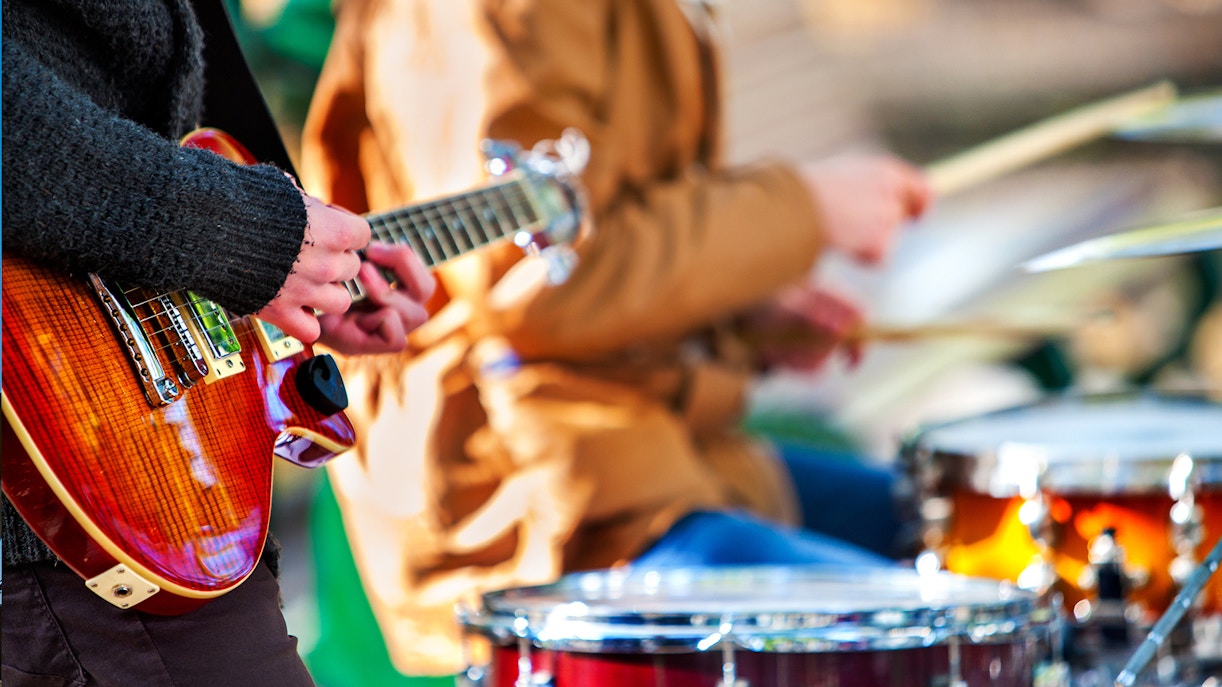 Guitarist and drummer performing live music.