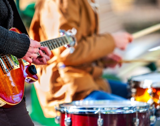 Guitarist and drummer performing live music.