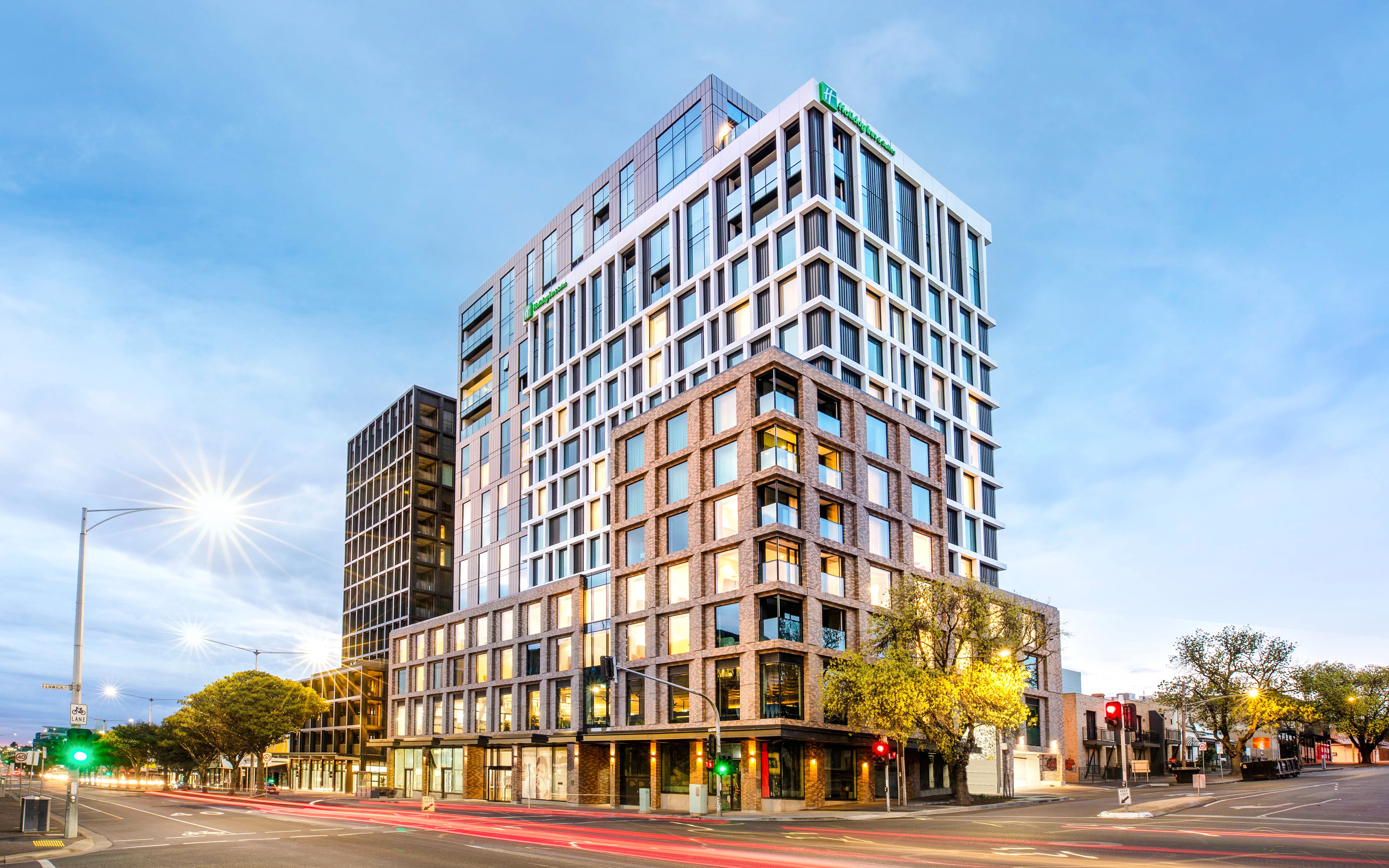 Holiday Inn & Suites Geelong exterior view at dusk with street lights.