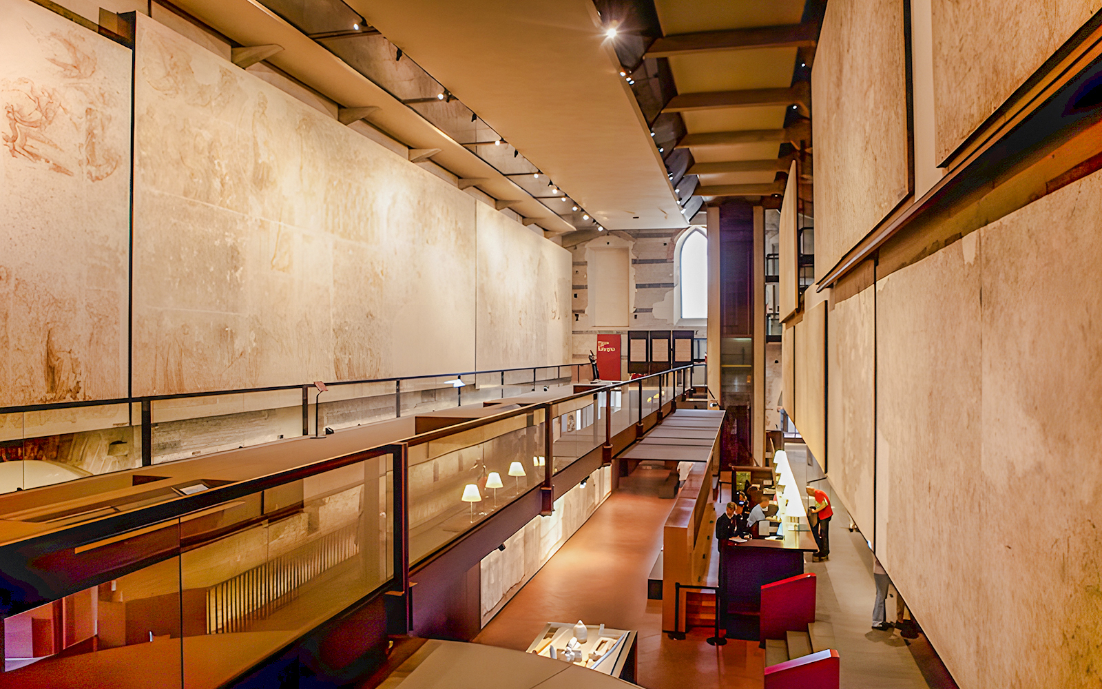 Interior view of the Sinopie Museum in Pisa showcasing frescoes and modern architecture.