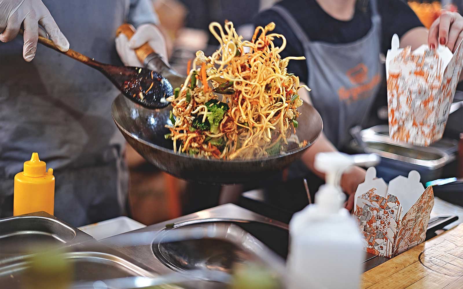 Stir-fried noodles being prepared at a street food stall during Bangkok Night Bike Tour.