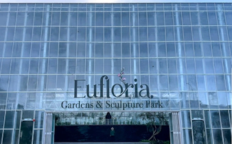 Eufloria Gardens & Sculpture Park entrance with glass facade.