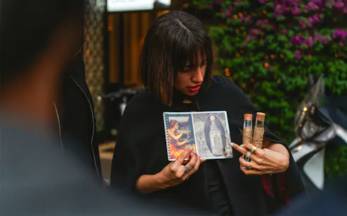 Guide showing images and artifacts during Rome legends and ghosts tour.