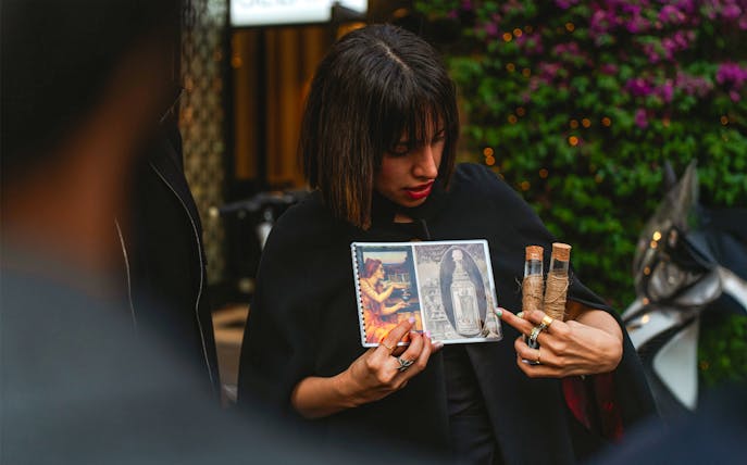 Guide showing images and artifacts during Rome legends and ghosts tour.
