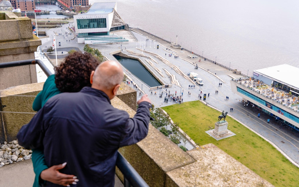 Guests overlooking Liverpool waterfront from Royal Liver Building.