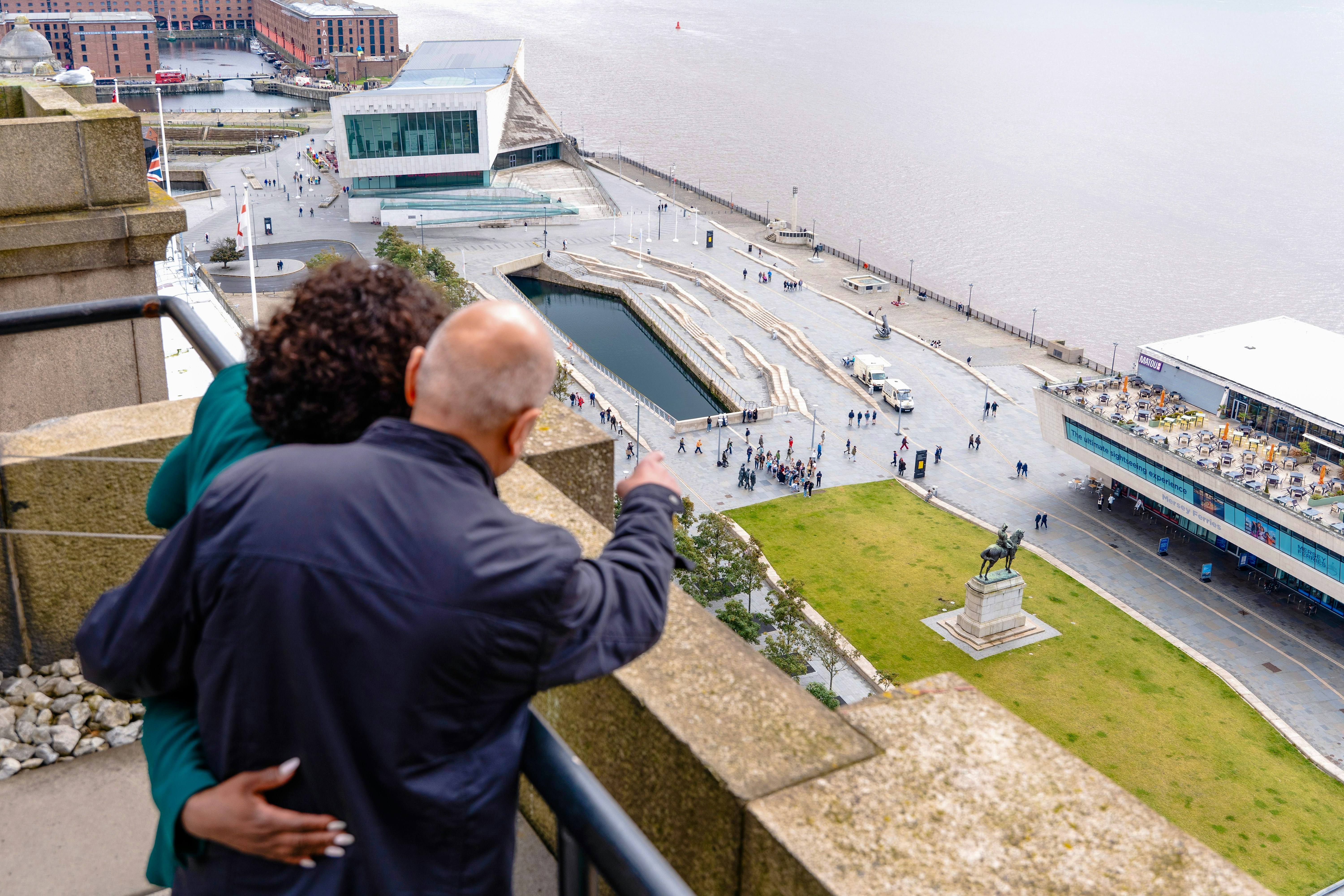 Guests overlooking Liverpool waterfront from Royal Liver Building.