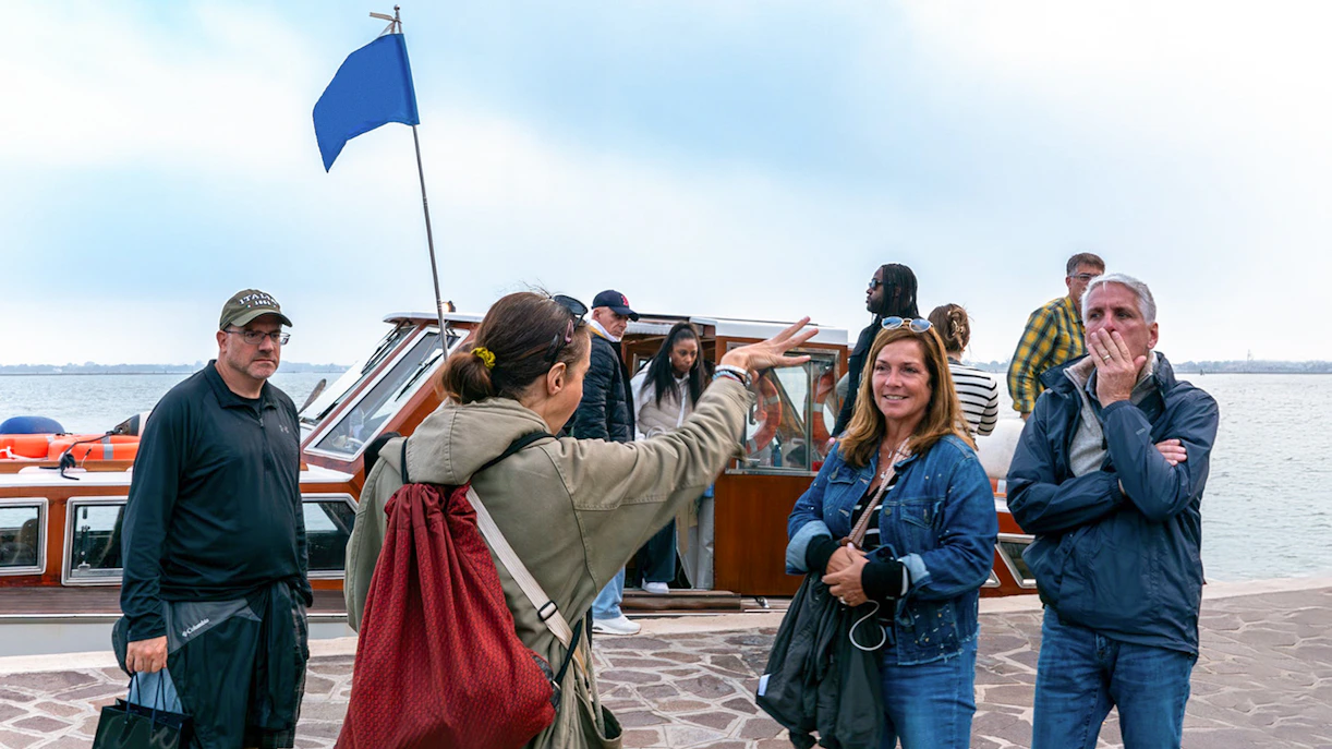 Tourists boarding a private boat for Murano and Burano Islands tour.