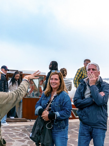 Tourists boarding a private boat for Murano and Burano Islands tour.
