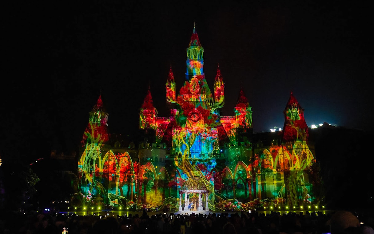 Light and sound show at Vinpearl, Nha Trang, illuminating a castle with vibrant projections.