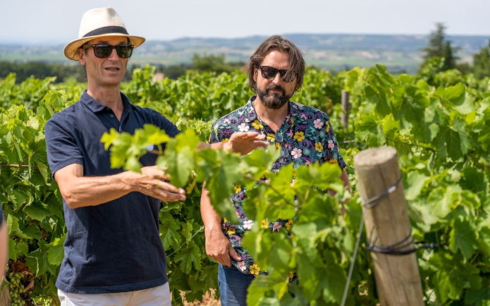 Men exploring vineyards in Chateauneuf du Pape, Avignon, France.