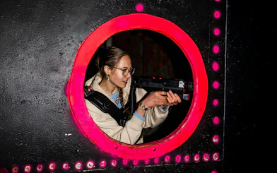 Person playing laser tag in Rotterdam arena.