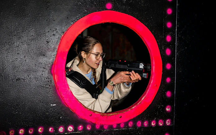 Person playing laser tag in Rotterdam arena.