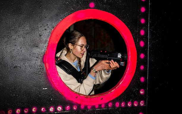 Person playing laser tag in Rotterdam arena.