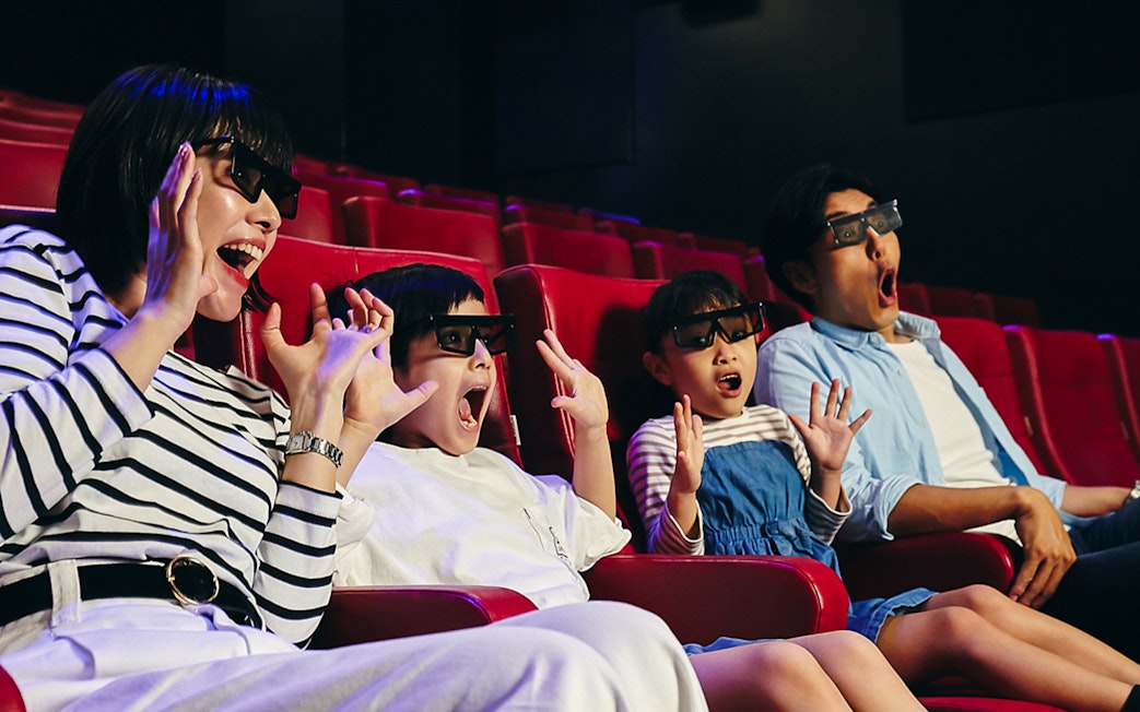 Family enjoying 4D cinema experience at LEGOLAND Discovery Center Tokyo.