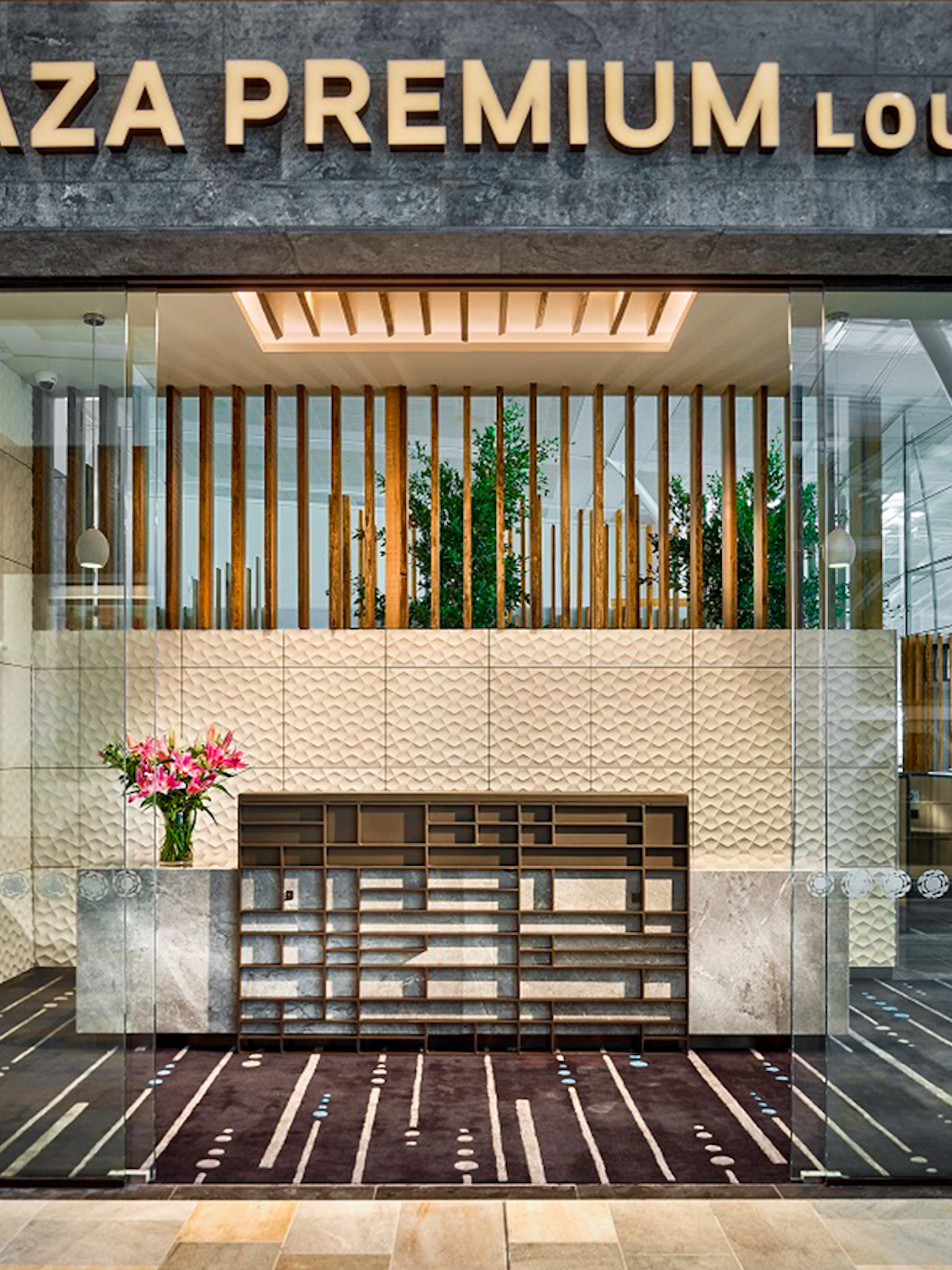 Plaza Premium Lounge entrance with modern decor and reception desk.