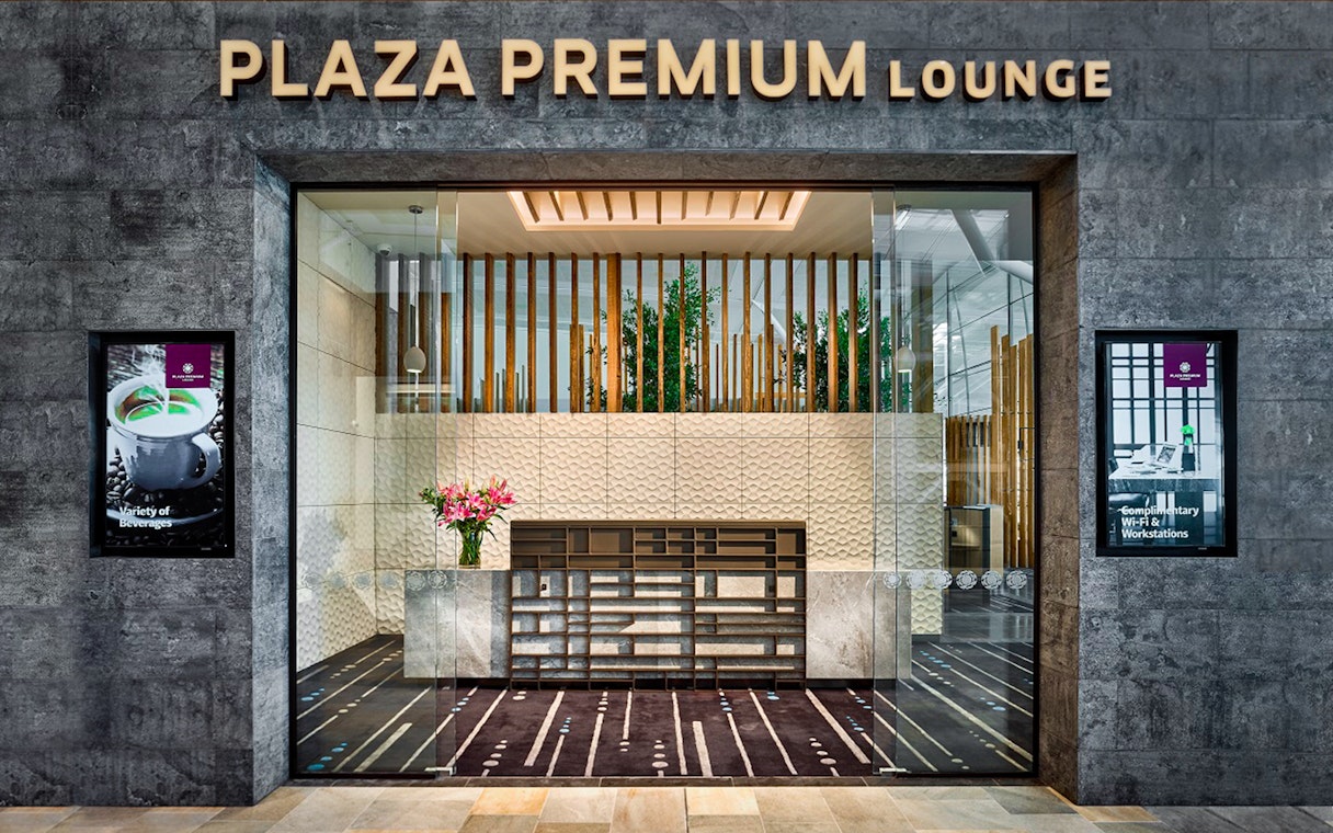 Plaza Premium Lounge entrance with modern decor and reception desk.