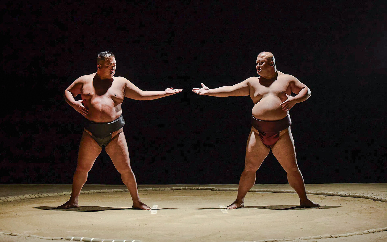 Sumo wrestlers facing off at The Sumo Hall Hirakuza in Osaka.