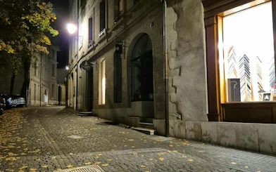 Cobblestone street in Geneva at night, part of the Murder Mystery city exploration game.