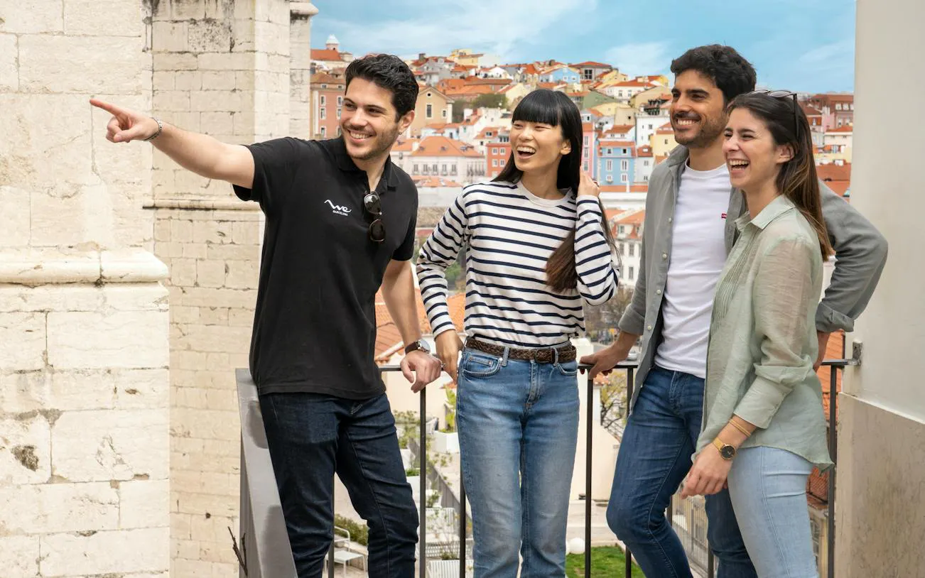 Group enjoying Lisbon's historic center with colorful buildings in the background.
