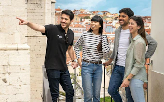 Group enjoying Lisbon's historic center with colorful buildings in the background.