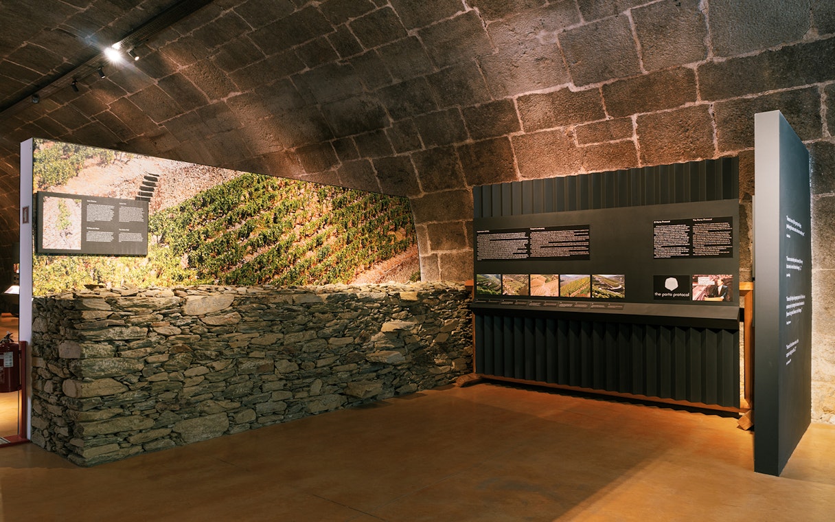 Fonseca port wine cellar exhibit with vineyard display and informational panels.