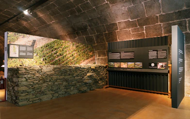 Fonseca port wine cellar exhibit with vineyard display and informational panels.
