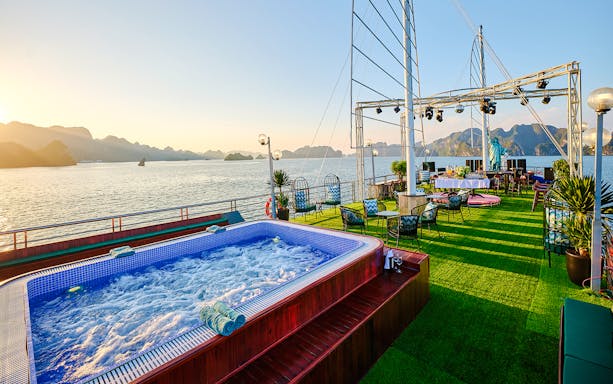 Jacuzzi on cruise ship deck at sunset in Ha Long Bay, Vietnam.