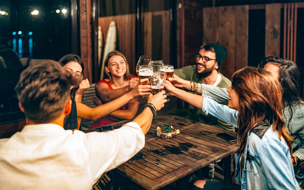 Group of friends toasting with beer during a 3-hour beer tour.