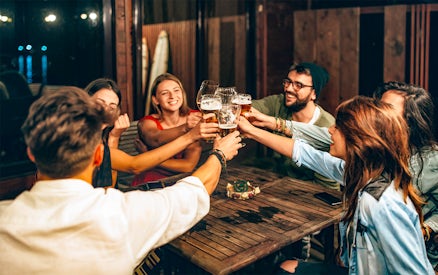 Group of friends toasting with beer during a 3-hour beer tour.
