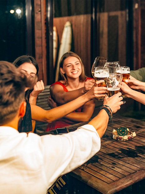 Group of friends toasting with beer during a 3-hour beer tour.