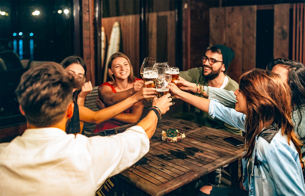 Prague beer tour group enjoying local brews at historic pub.