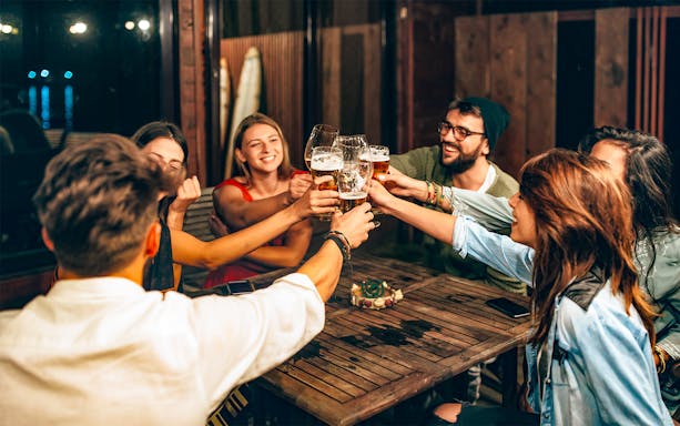 Group of friends toasting with beer during a 3-hour beer tour.