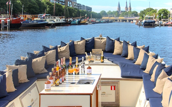 Luxury canal cruise boat with drinks setup in Amsterdam.