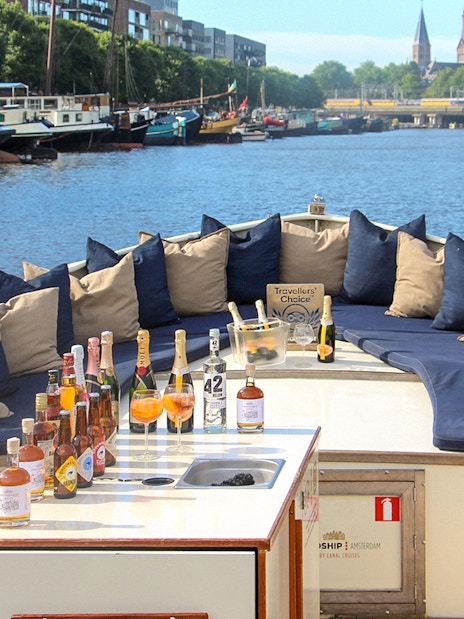 Luxury canal cruise boat with drinks setup in Amsterdam.