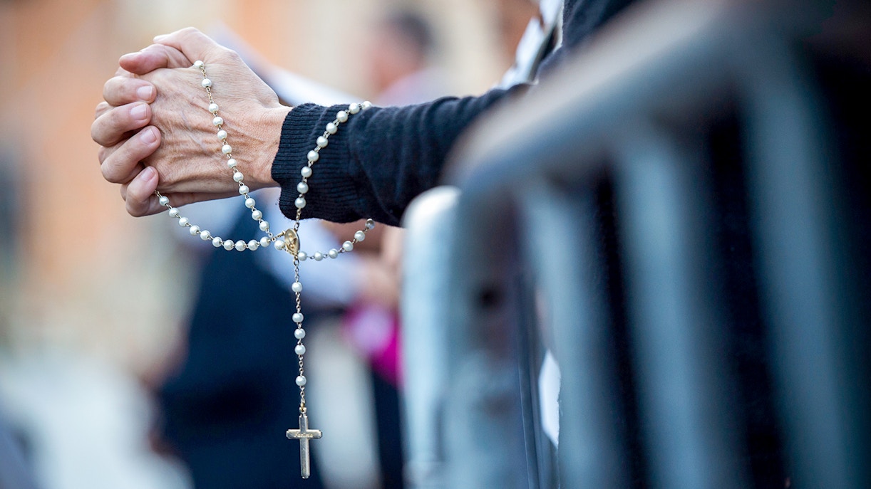 Pilgrim praying at the Archbasilica of St John Lateran during a Vatican Jubilee 2025 mass