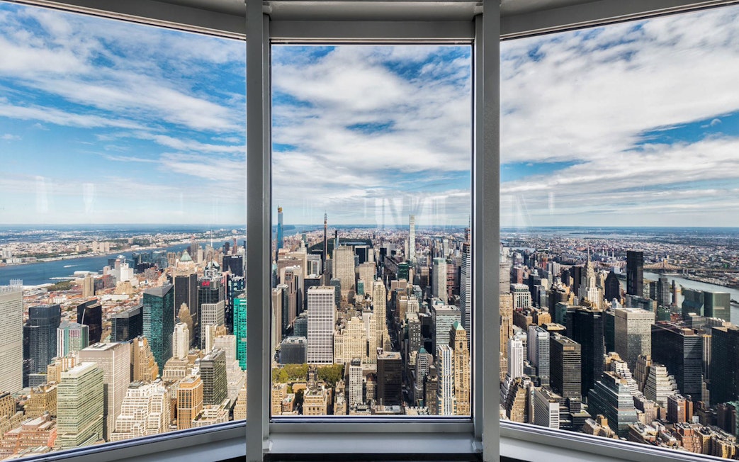 View of New York City skyline from Empire State Building's 86th floor observatory.