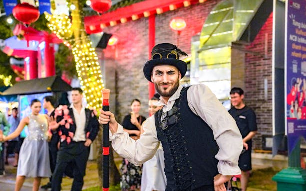 Performer in costume entertaining crowd at Da Nang Downtown event.