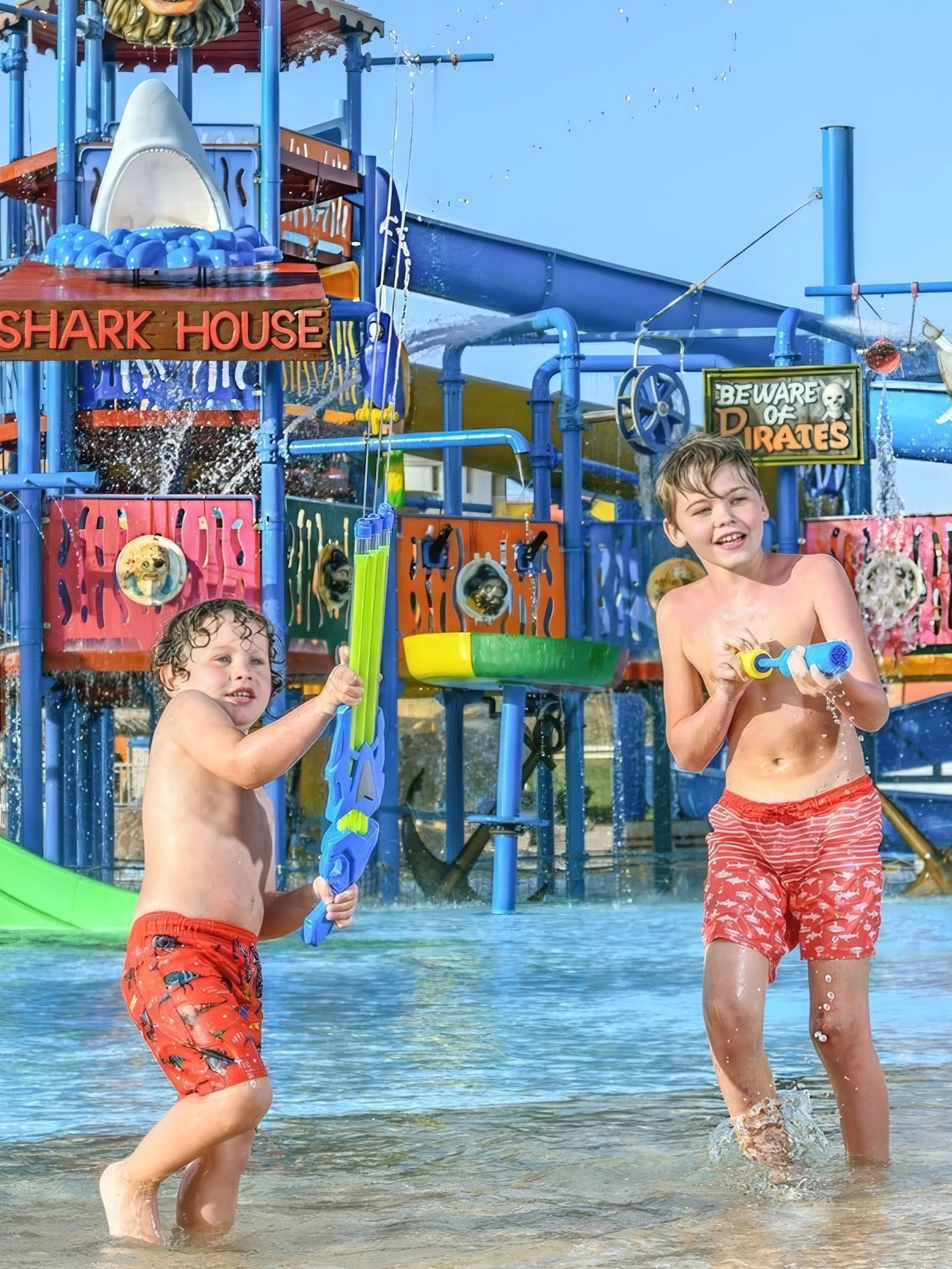 Boys playing with water guns at Makadi Water World, Hurghada.