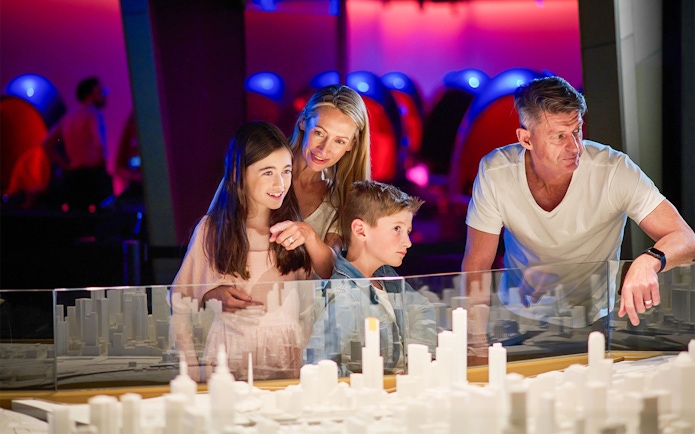 Family observing miniature city model at Melbourne Skydeck.