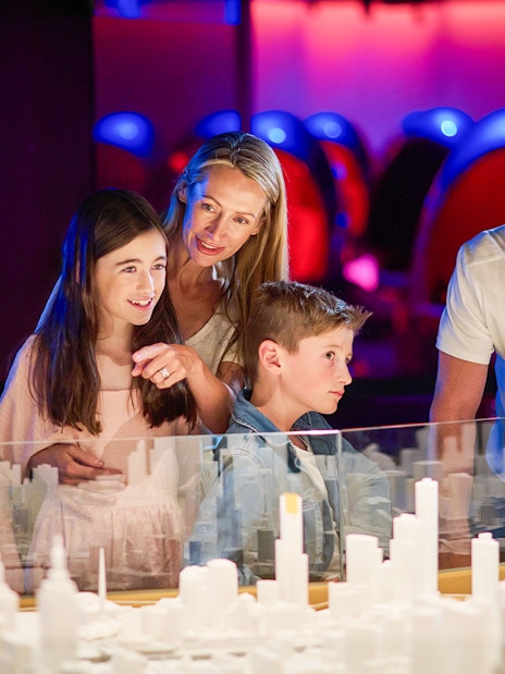 Family observing miniature city model at Melbourne Skydeck.