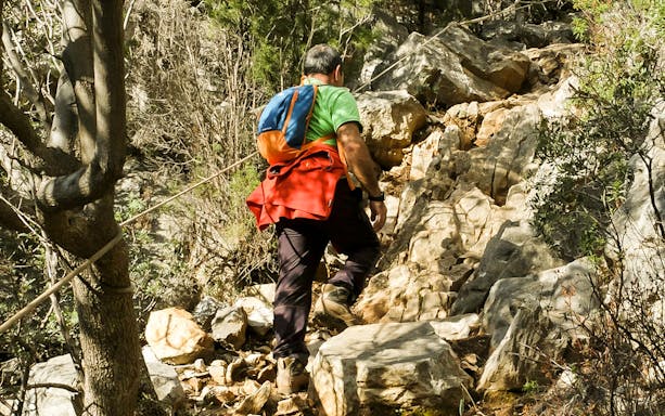 Trekking path along coastal cliffs from Masua to Cala Domestica, Sardinia.