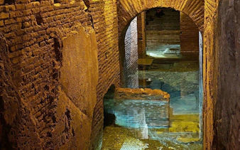Subterranean aqueducts beneath Piazza Navona, showcasing ancient Roman brickwork and arches.