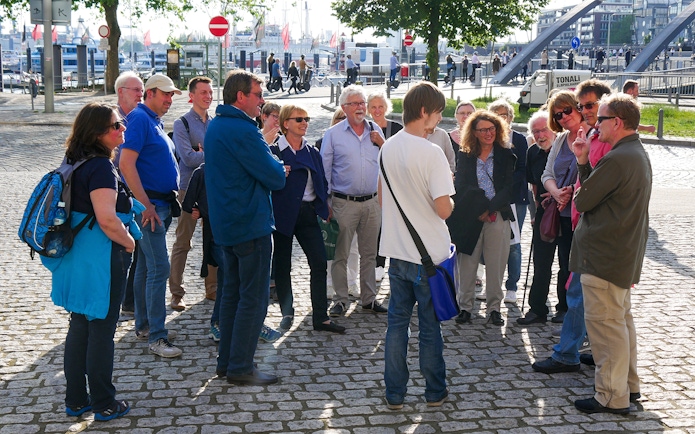 Group on Elbphilharmonie Plaza guided tour in Hamburg, near harbor.