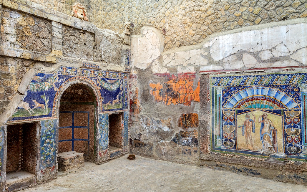 Ancient mosaics in Herculaneum, Italy, showcasing vibrant artwork and historical architecture.