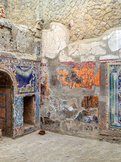 Ancient mosaics in Herculaneum, Italy, showcasing vibrant artwork and historical architecture.