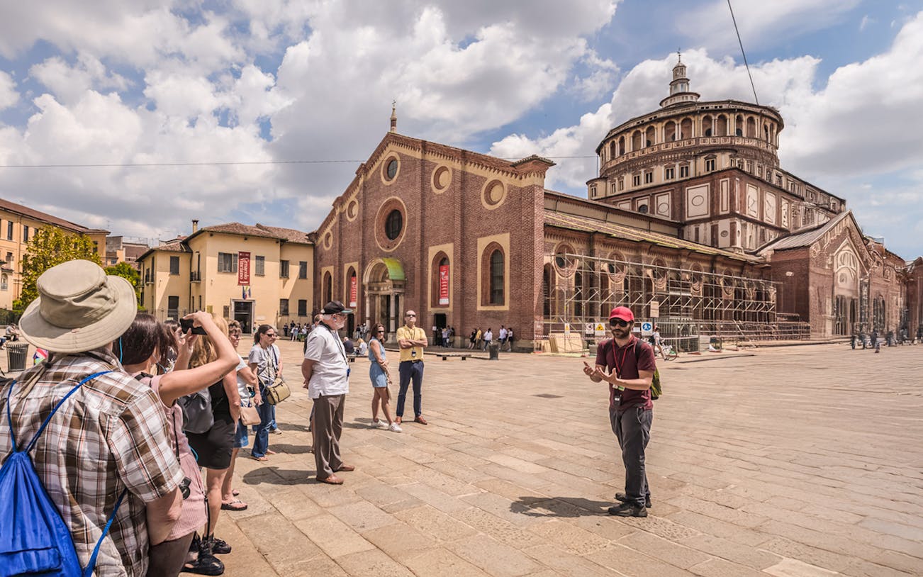 Tourists exploring the historic Duomo di Milano cathedral on a guided walking tour in Milan.