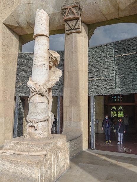 Sculpture and entrance detail at Sagrada Familia, Barcelona, during a guided tour.